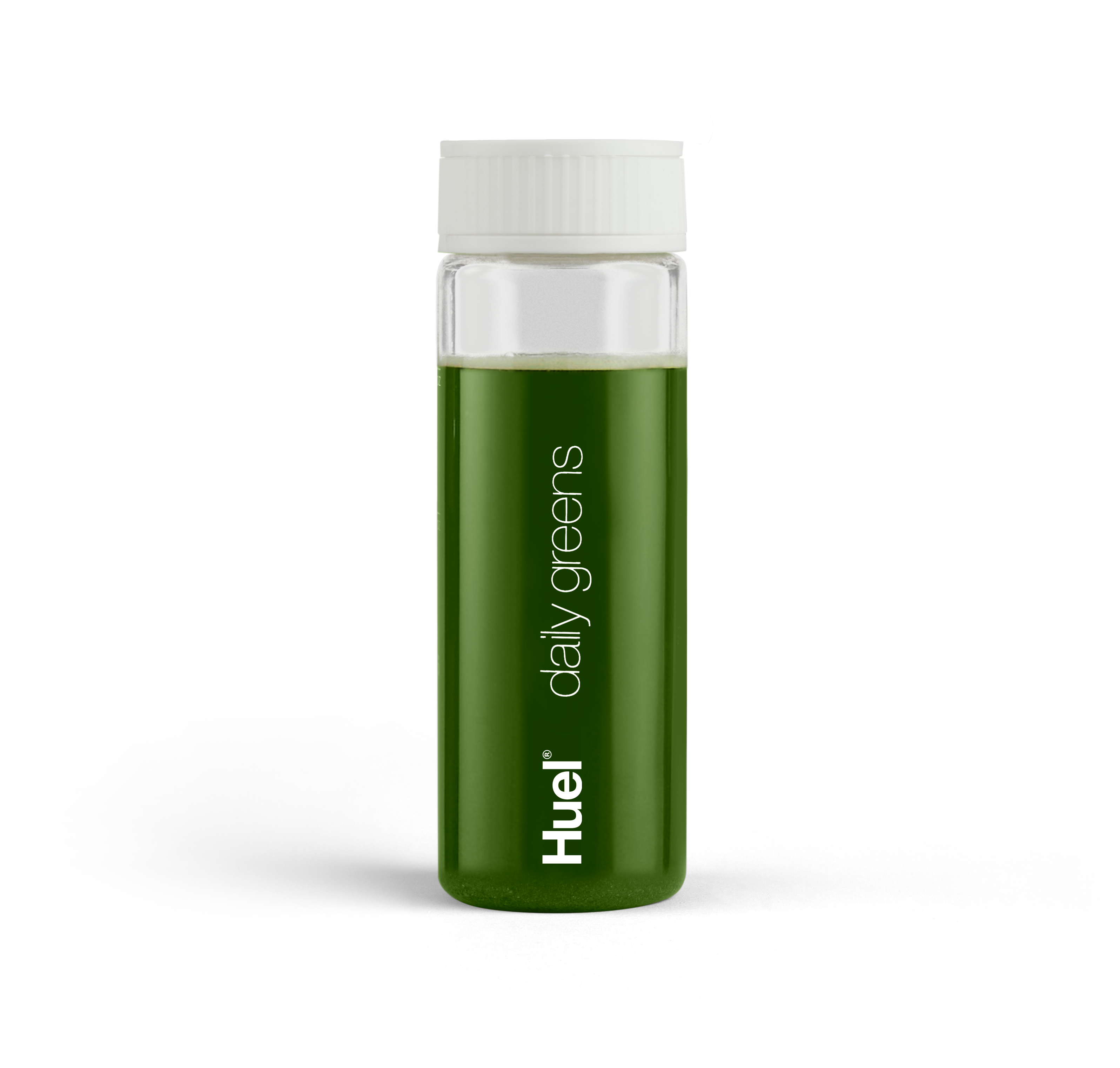 Eine Flasche Huel Daily Greens vor einem Hintergrund aus weißem Pulver