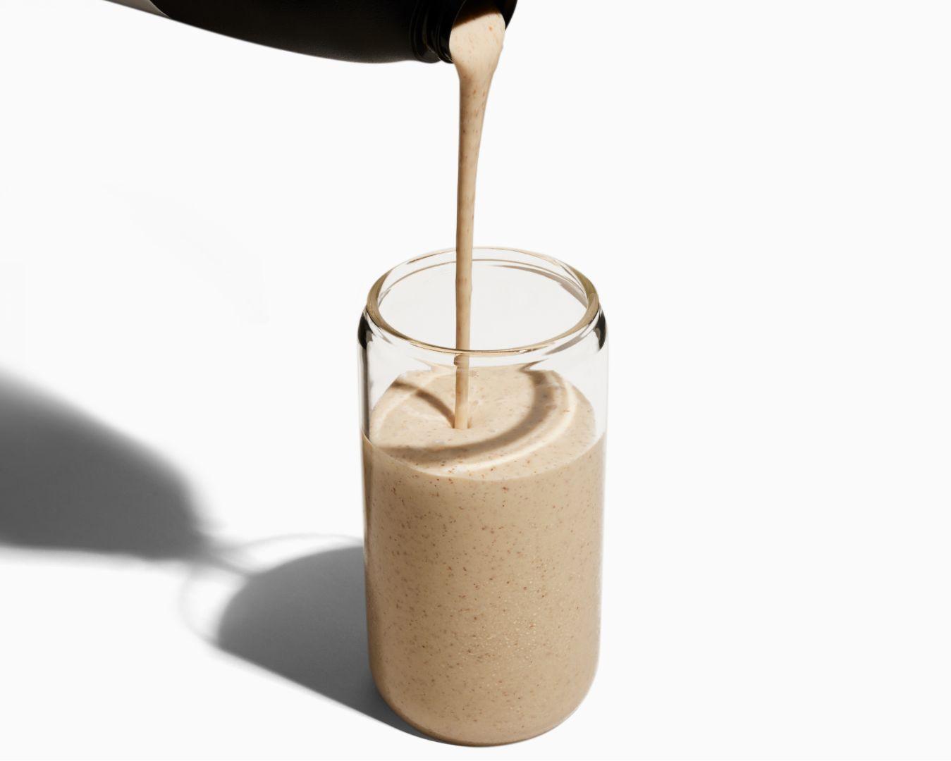 Image of Huel Black Edition meal replacement drink being poured from a shaker into a glass