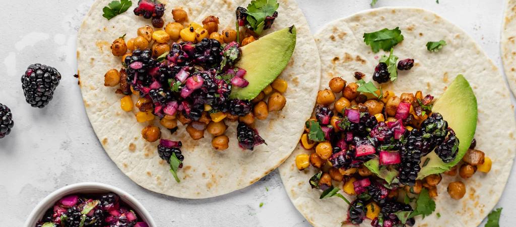 Two blackberry tacos with avocado and chickpeas