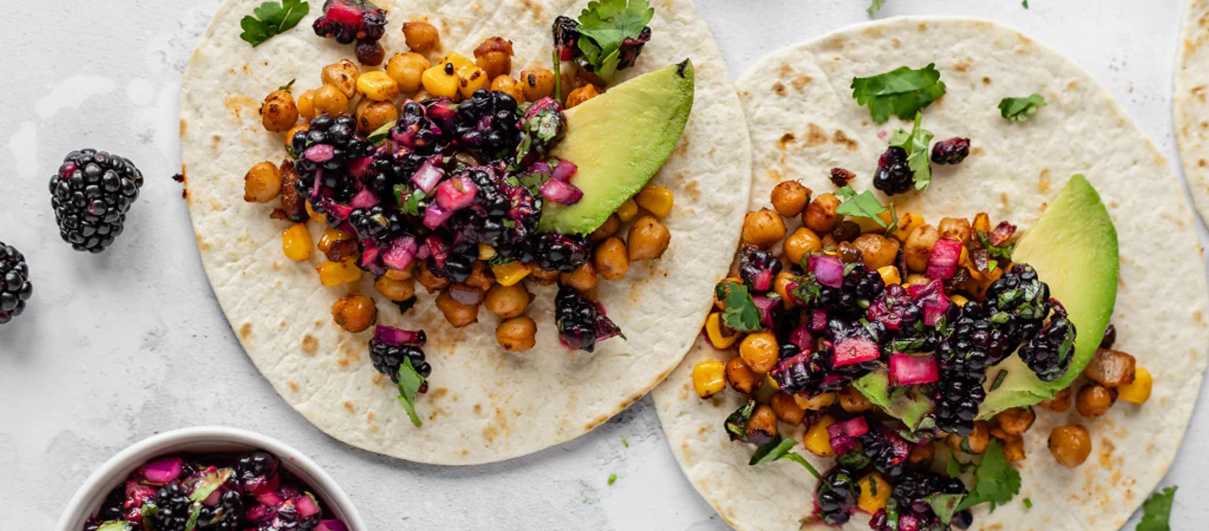 Two blackberry tacos with avocado and chickpeas