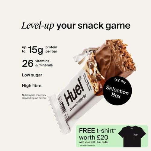 A Huel Complete Nutrition bar with a peanut and caramel filling, set against a beige-colour background