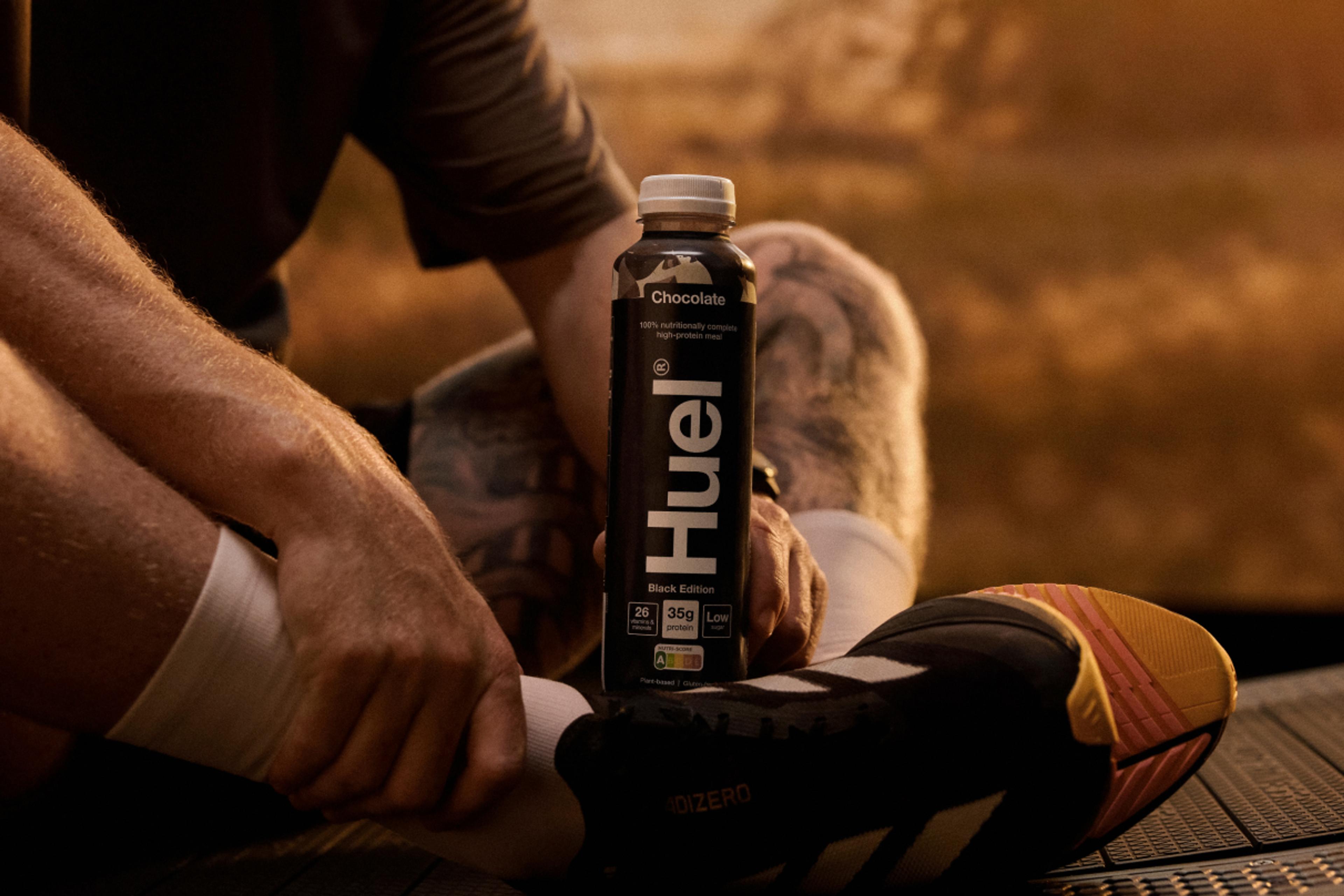 Man sat with Huel BE RTD at Sunset