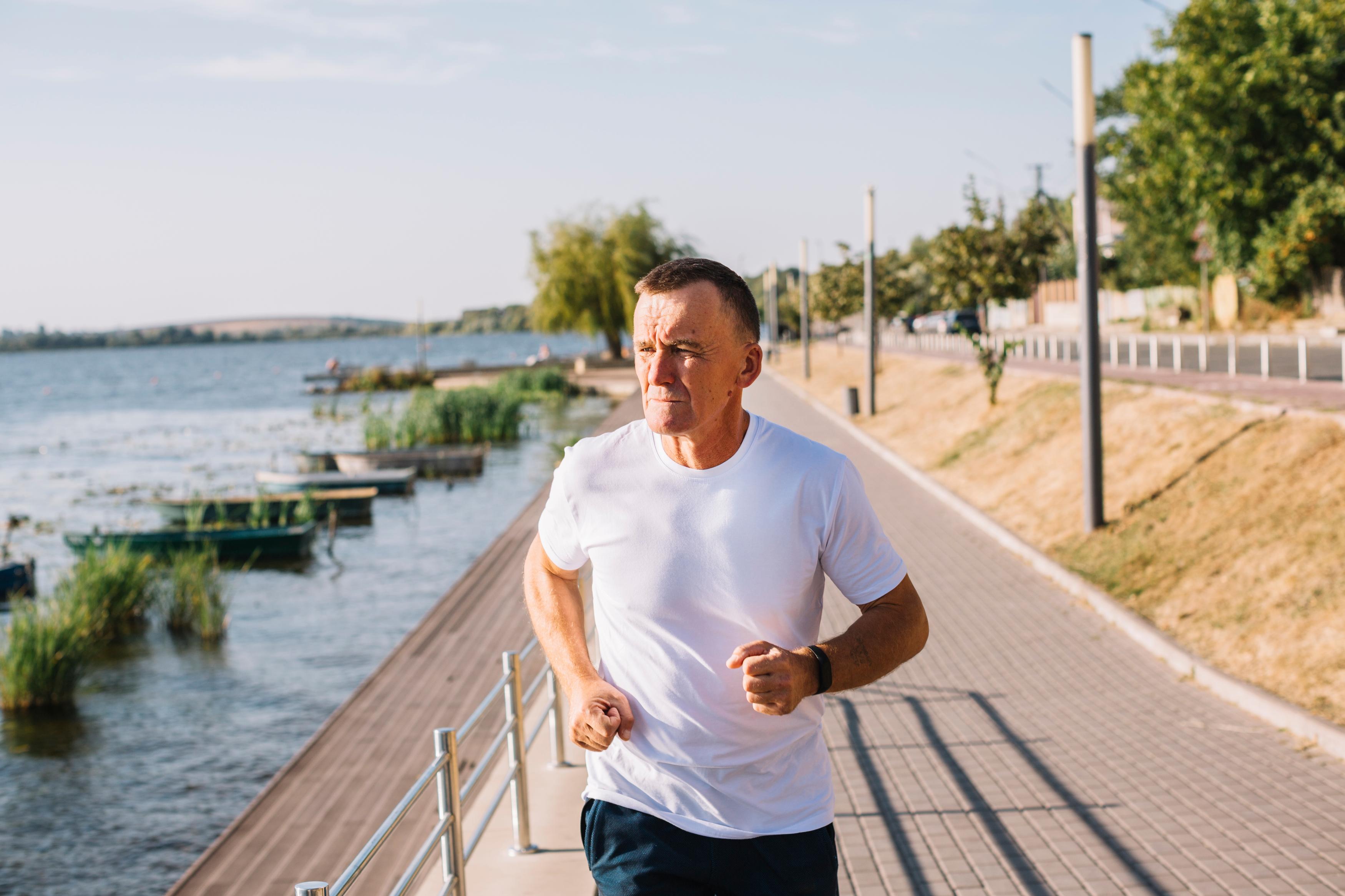 man running outside along a lake