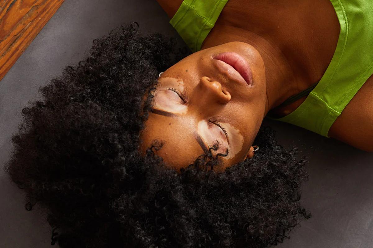 woman laying on a yoga mat with her eyes closed