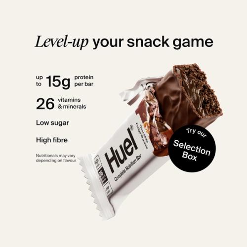 Alt: Huel Complete Nutrition Bar with a cut-open bar, alongside text highlighting up to 15g protein, 26 vitamins and minerals, low sugar, and high fibre.
