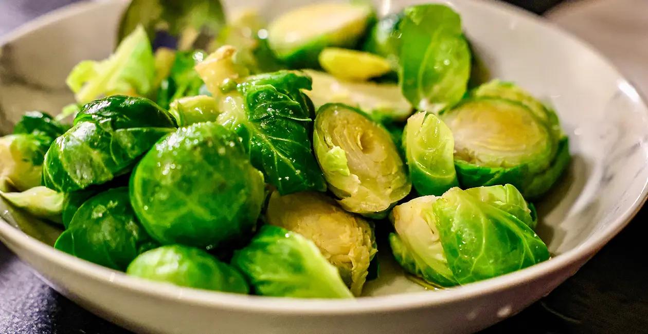 cooked brussel sprouts cut in half and in a bowl