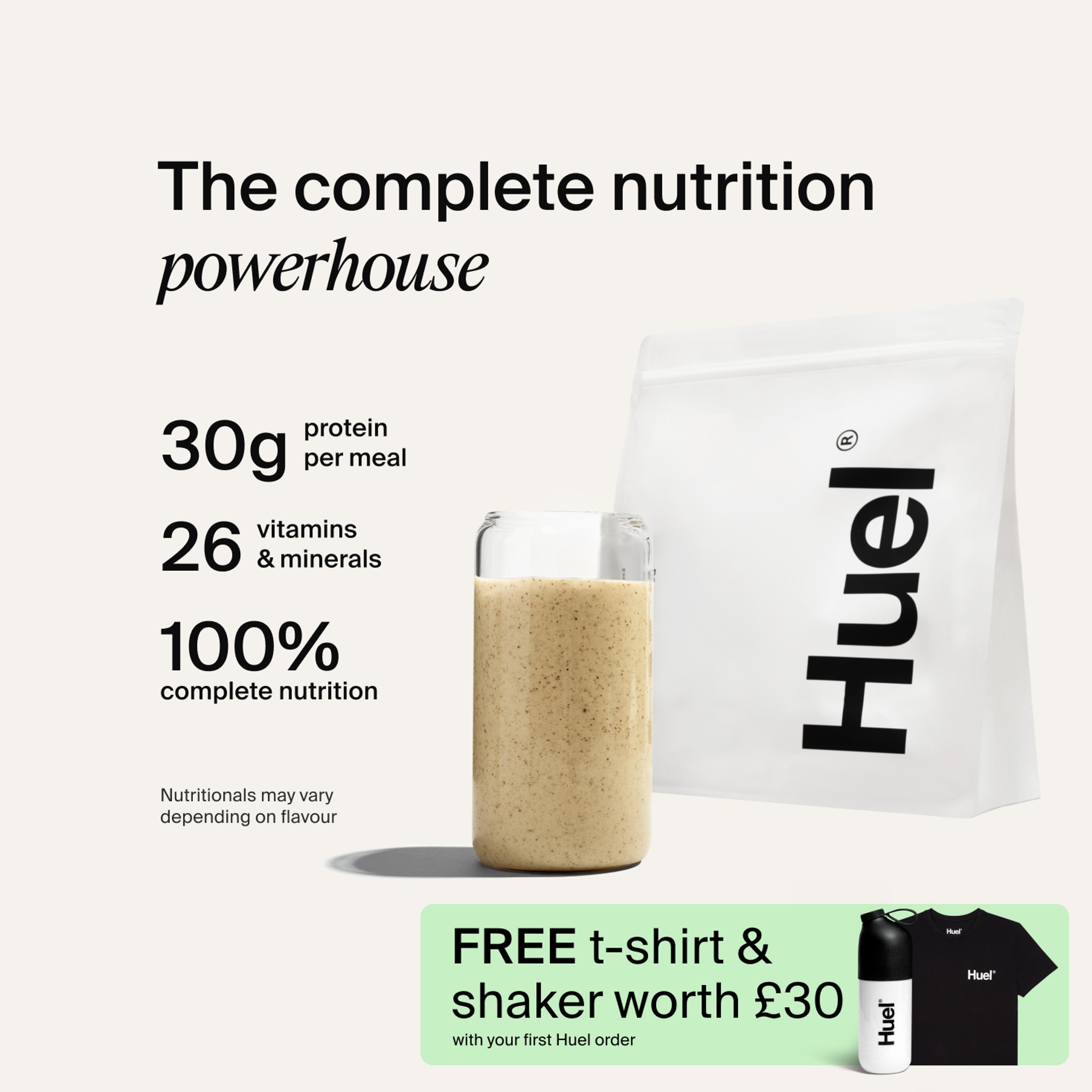 A bag of Huel powder next to a glass containing a Huel drink on a neutral background