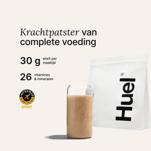 A bag of Huel powder next to a glass containing a Huel drink on a neutral background