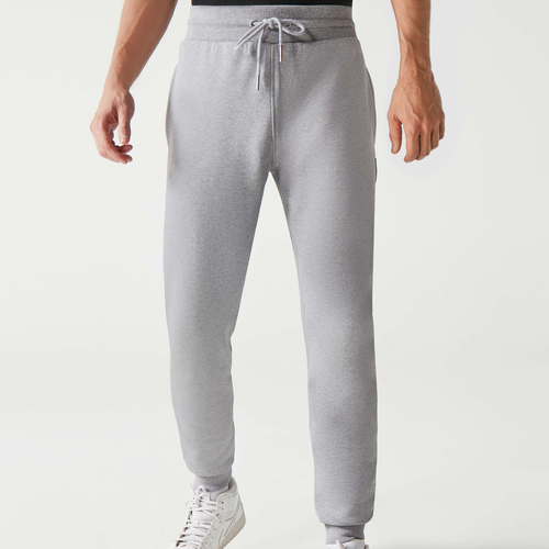 A man wearing grey Huel joggers