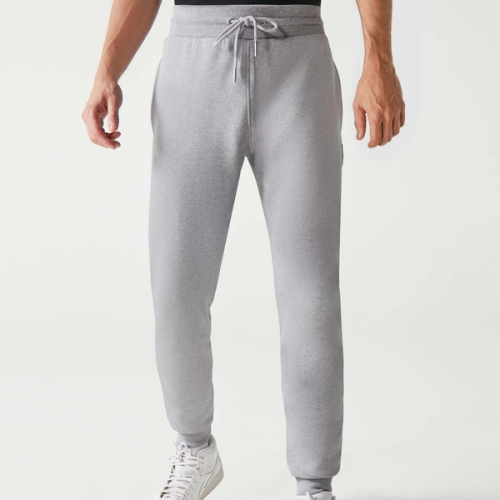 A man wearing grey Huel joggers