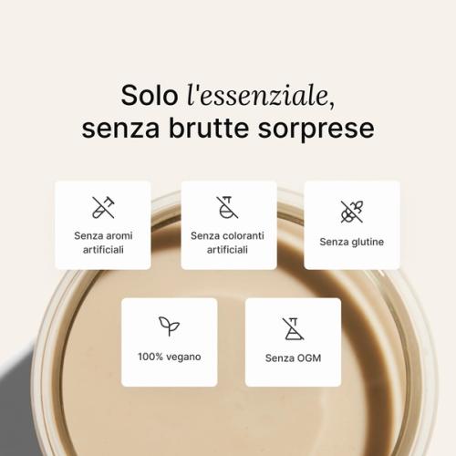 A glass of Huel complete protein shake on a neutral colour background