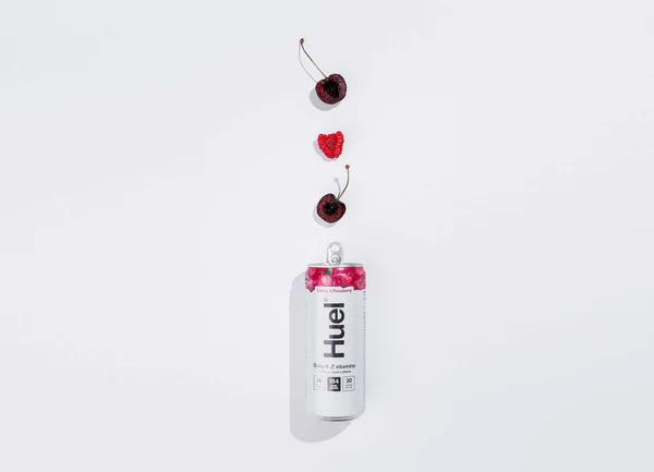 Can of Huel Daily A-Z Vitamins energy drink with fresh ingredients above it including cherry and raspberry