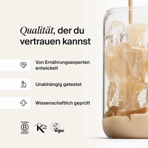 A glass of ice being filled by huel complete protein liquid