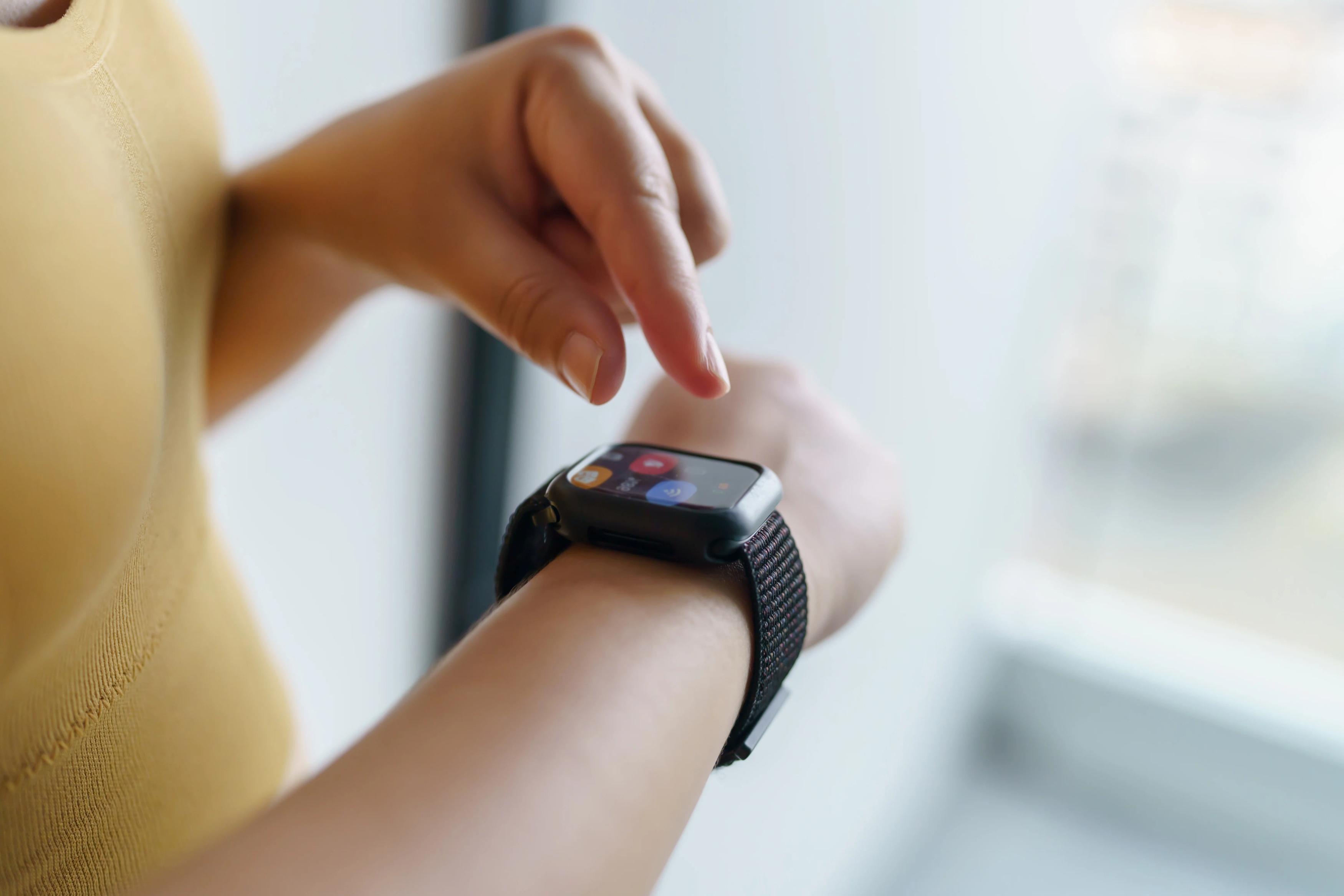 a person using their smart watch on their wrist