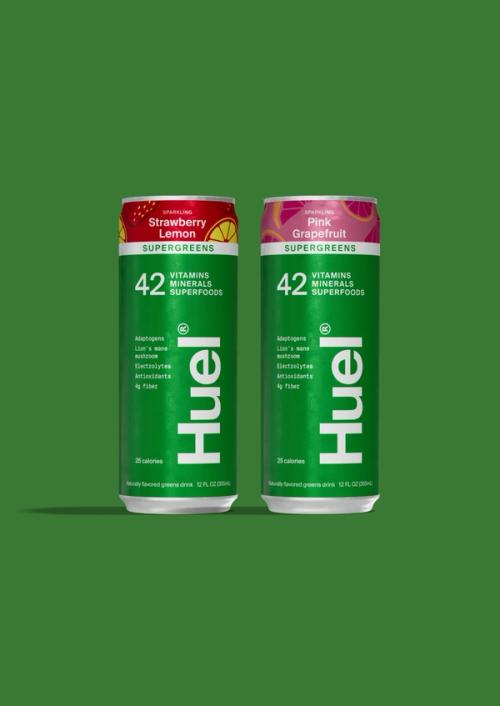 The 3 flavours of Huel Daily Greens Ready-to-drink sat on a shelf with a person lifting one of them off
