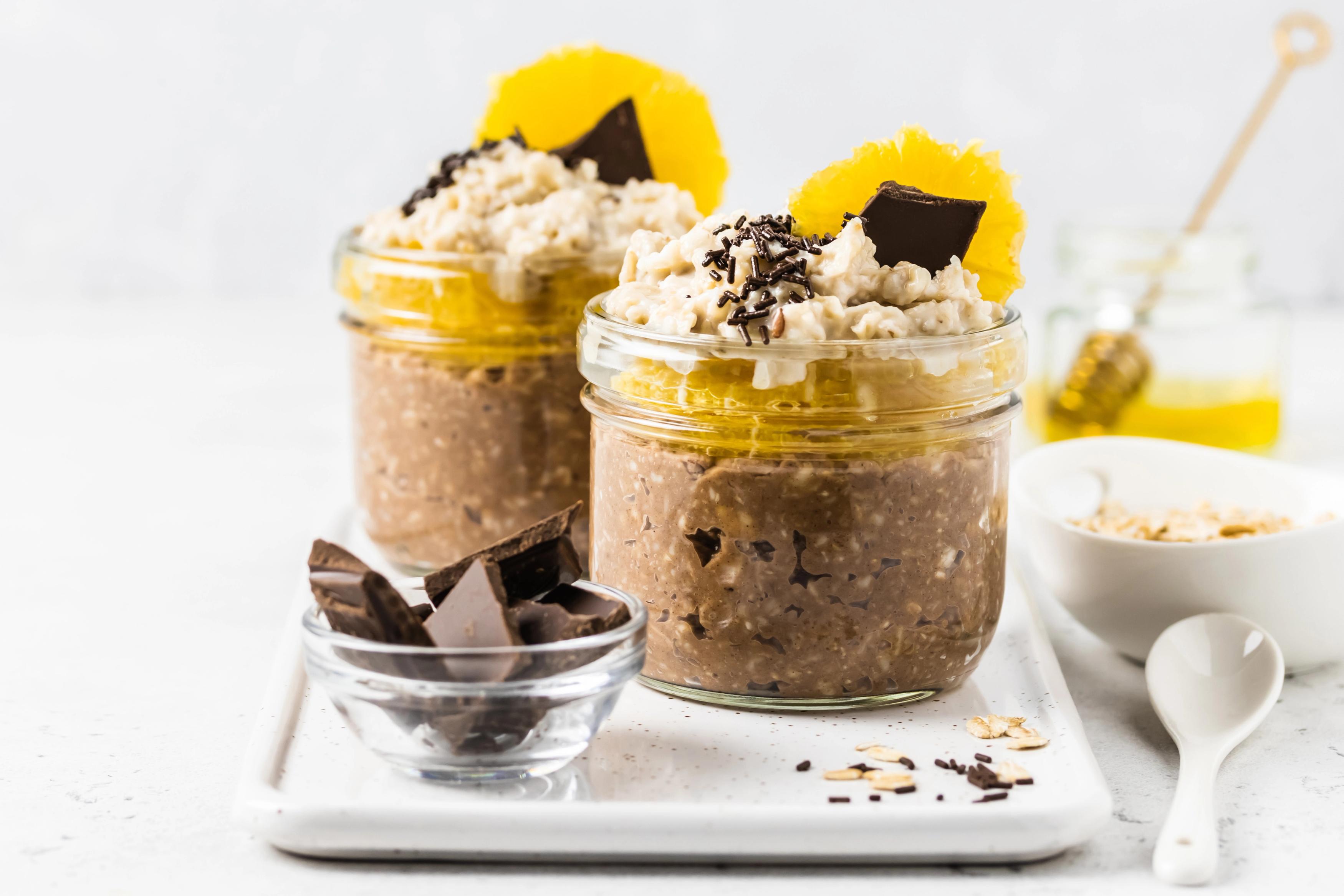 Chocolate protein orange slices overnight oats in glasses.