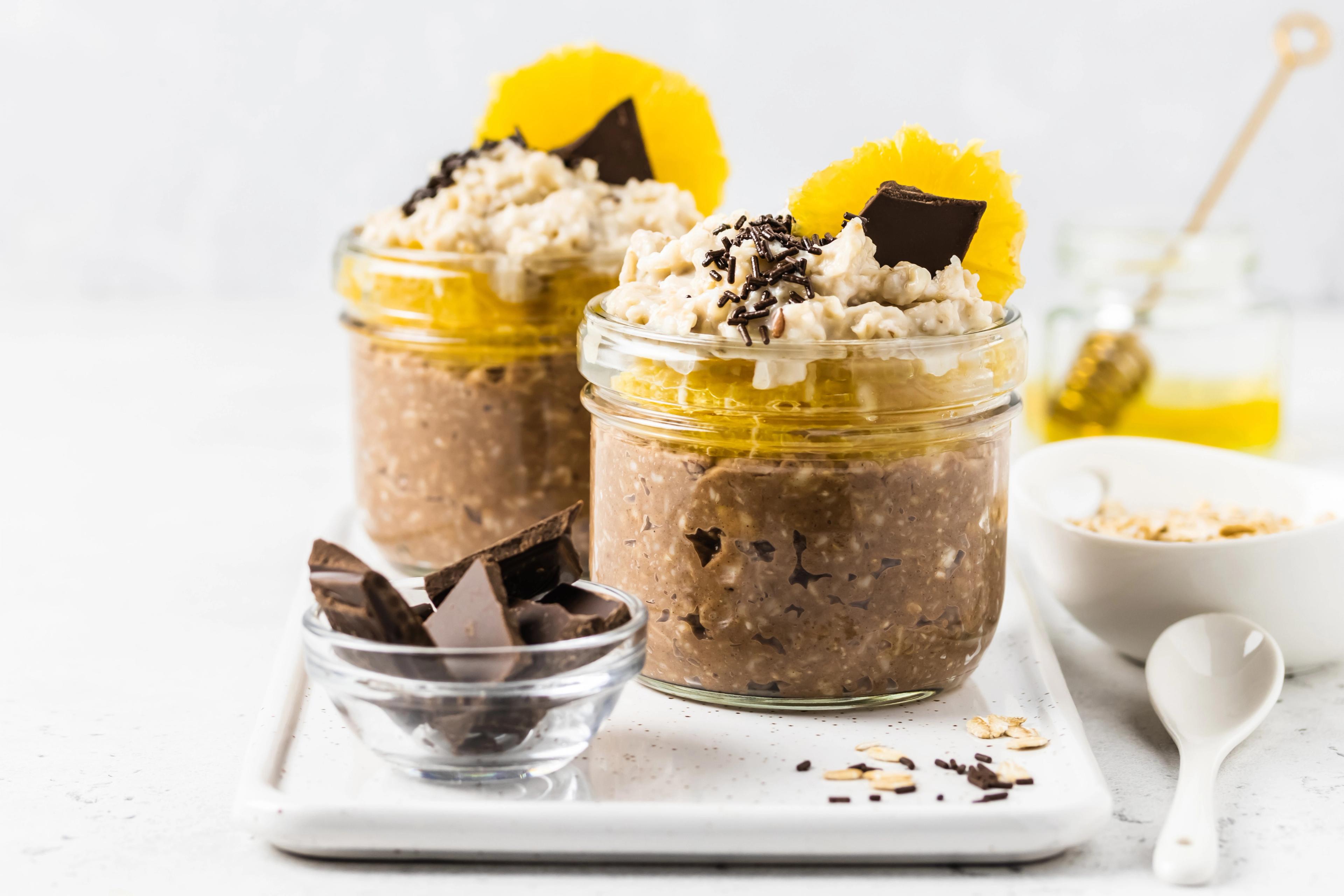 Chocolate protein orange slices overnight oats in glasses.