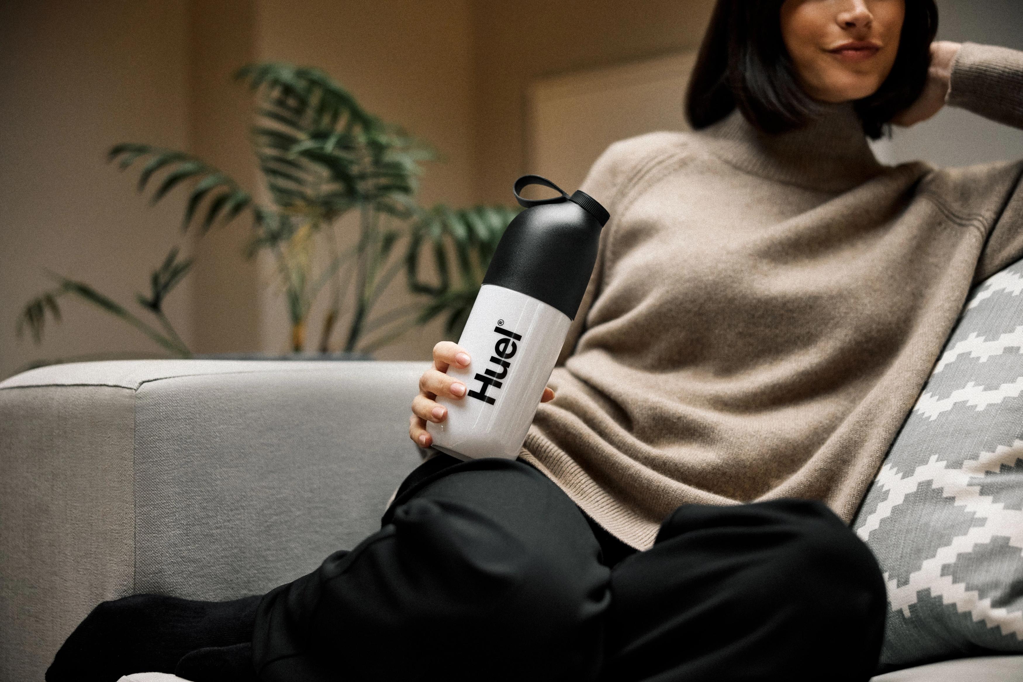 woman waking up in bed and stretching with her eyes closed