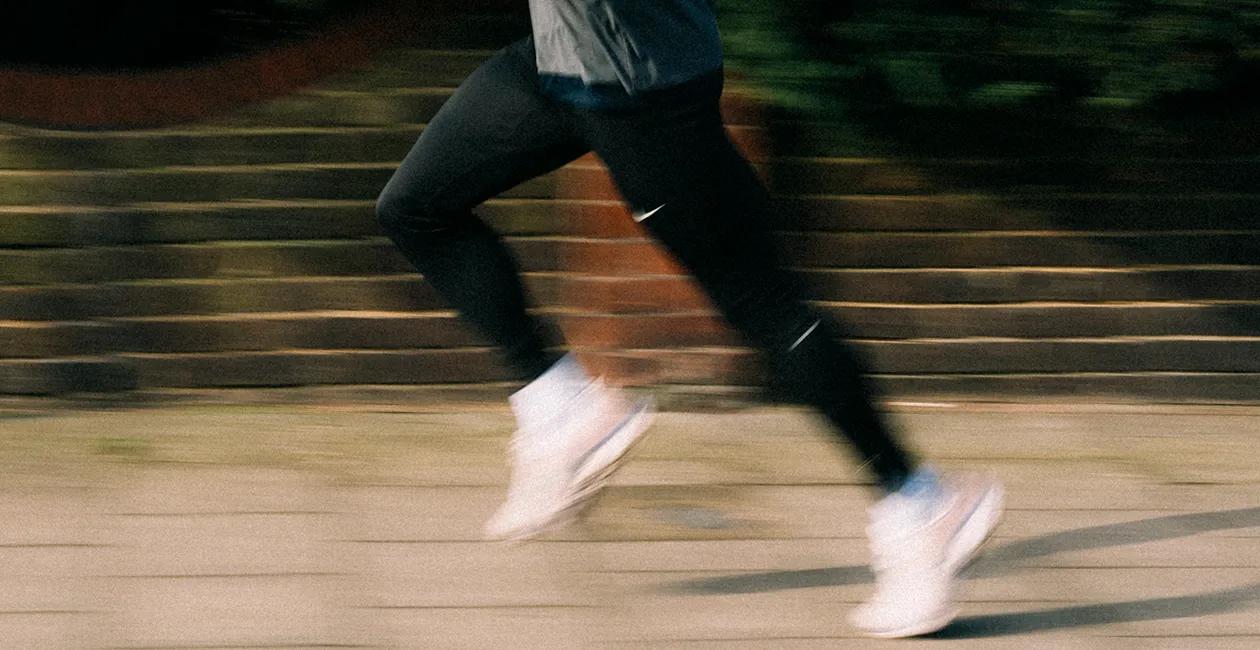 blurred image of someones legs as they run outside