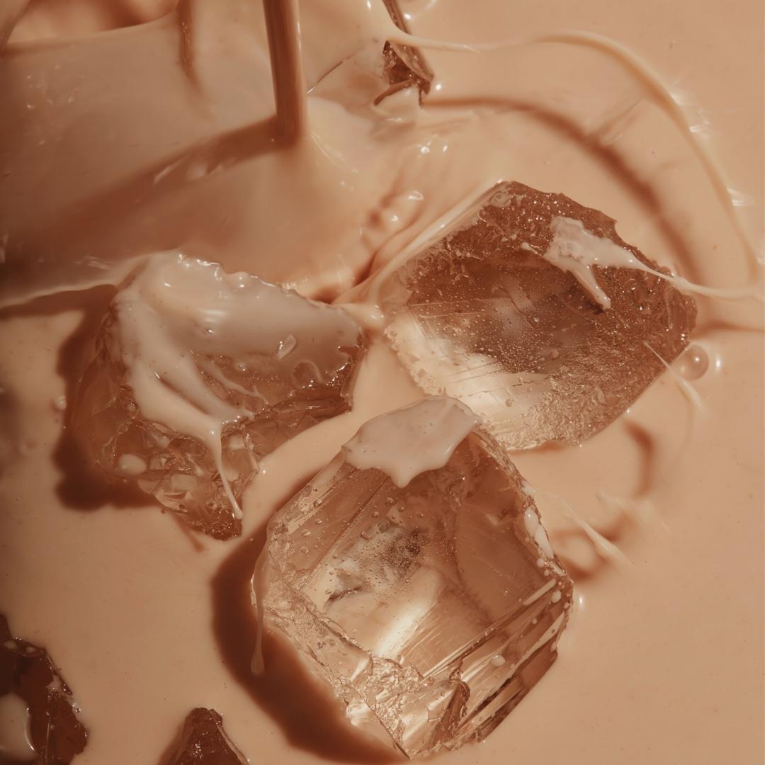 Huel Chocolate Black Edition RTD with ice cubes in a glass