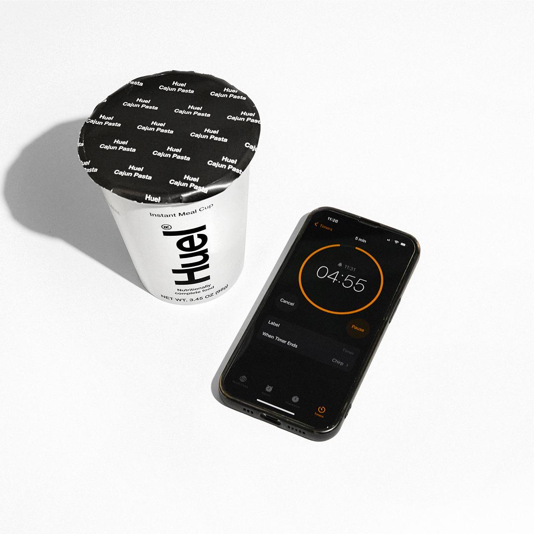 Someone setting the timer on a microwave