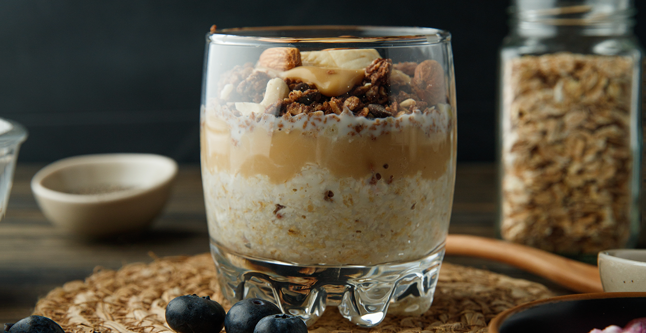 A glass showing the layers of overnight oats