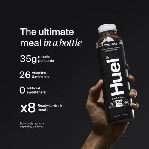 A hand holding a bottle of Huel Black Edition ready-to-drink on a black background