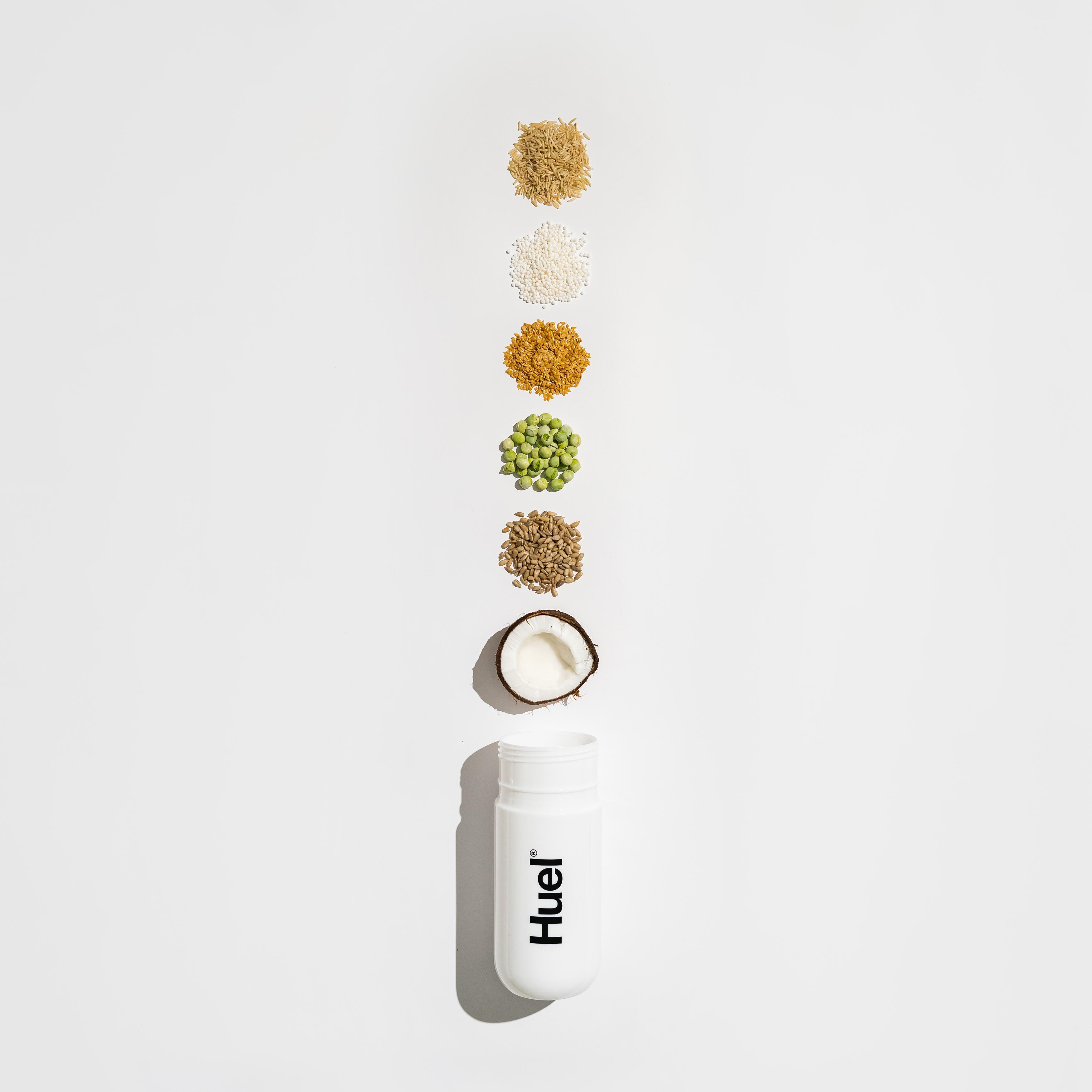 huel shaker with varying plant based ingredients coming out of the top