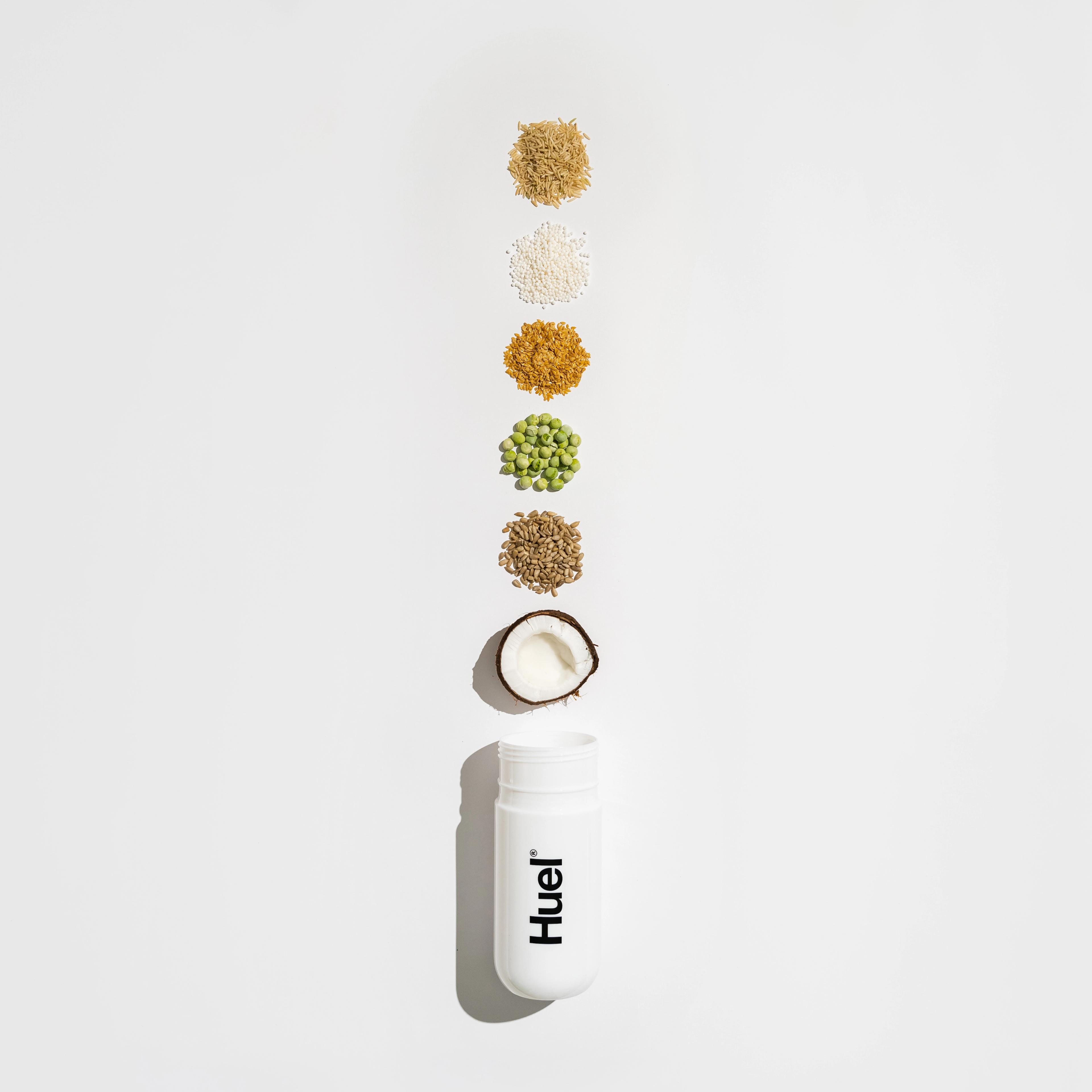 huel shaker with varying plant based ingredients coming out of the top