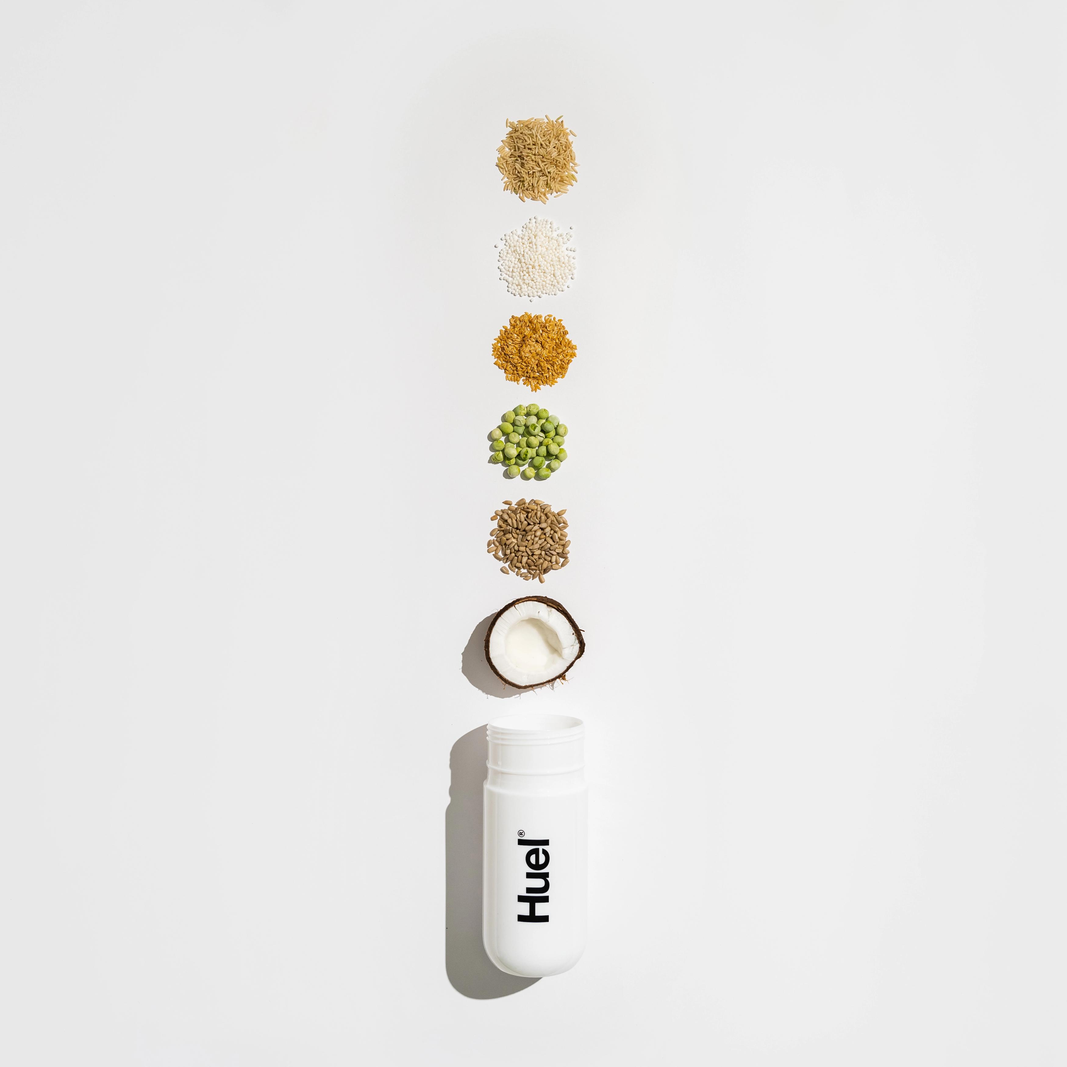 huel shaker with varying plant based ingredients coming out of the top