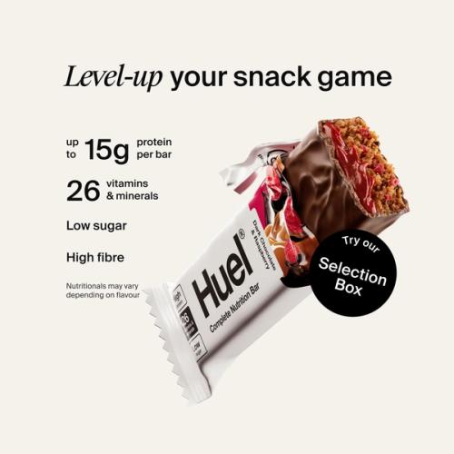 Alt: Huel Complete Nutrition Bar with a cut-open bar, alongside text highlighting up to 15g protein, 26 vitamins and minerals, low sugar, and high fibre.