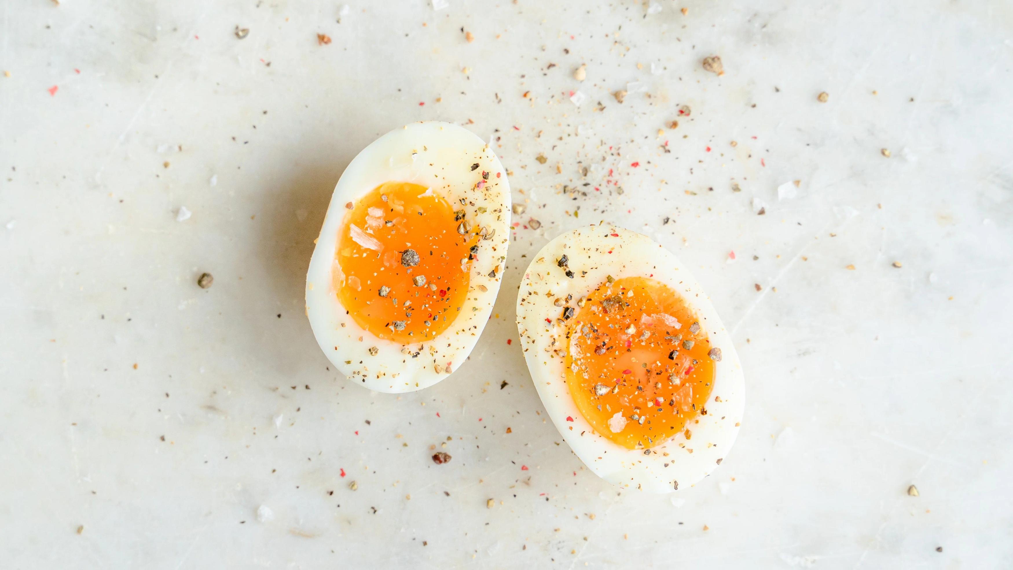 Boiled egg cut in half with seasoning on top