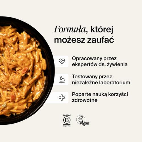 A bowl of Huel Hot & Savoury with fresh chilli and coriander on a neutral background