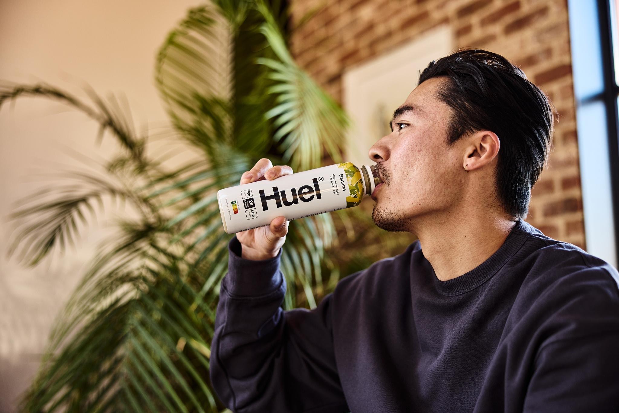 man drinking a Huel ready to drink banana meal replacement shake