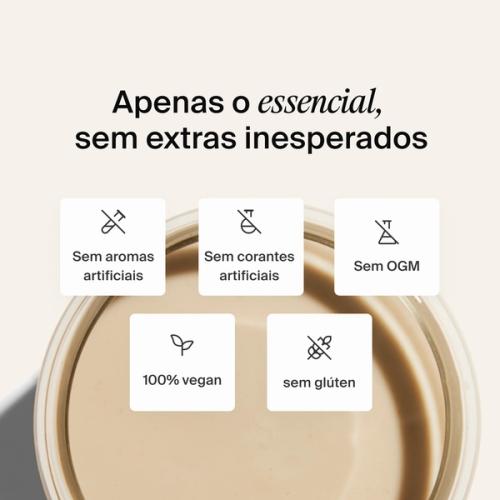 A glass of Huel complete protein shake on a neutral colour background