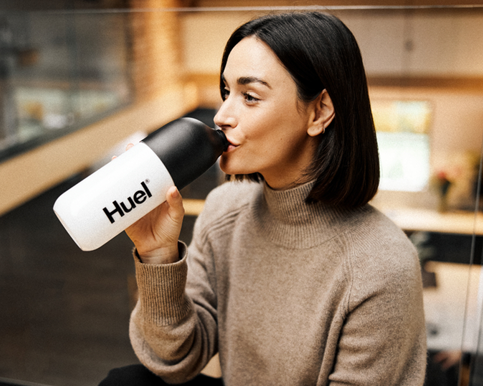 Lady Drinking out of a Huel Shaker