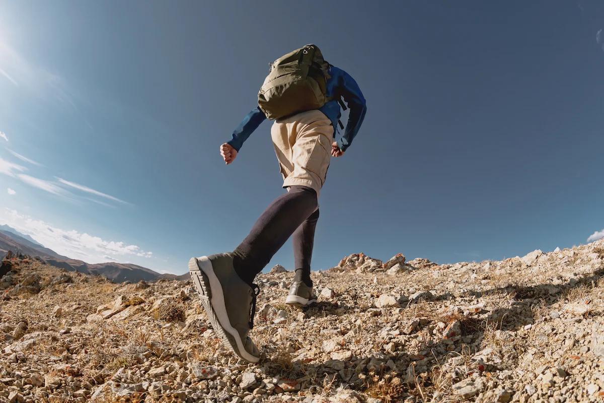 Person rucking up a mountain with a backpack on