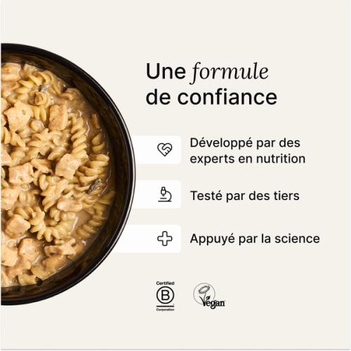 A bowl of Huel Hot & Savoury with fresh chilli and coriander on a neutral background