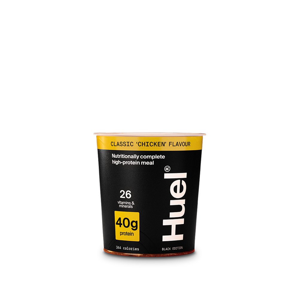 A Huel Black Edition Ramen pot in classic 'chicken' flavour on a plain background