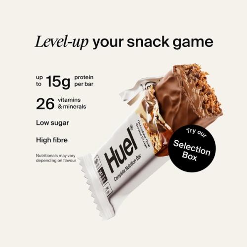 Alt: Huel Complete Nutrition Bar with a cut-open bar, alongside text highlighting up to 15g protein, 26 vitamins and minerals, low sugar, and high fibre.