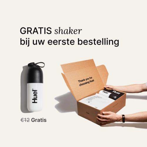 someone holding a Huel box containing a white powder bag, and a black and white shaker, on a neutral background