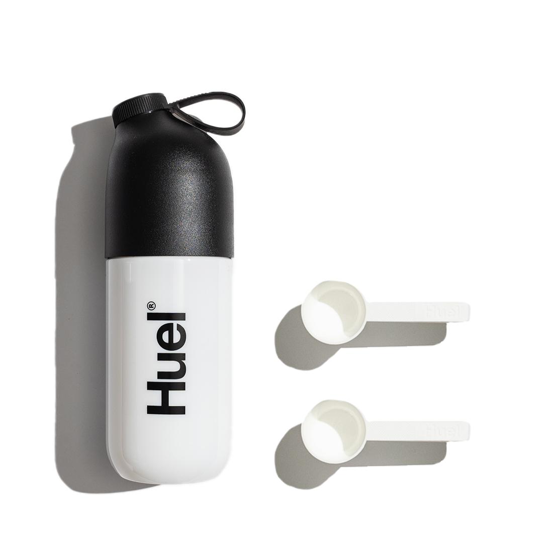 Huel shaker next to two scoops