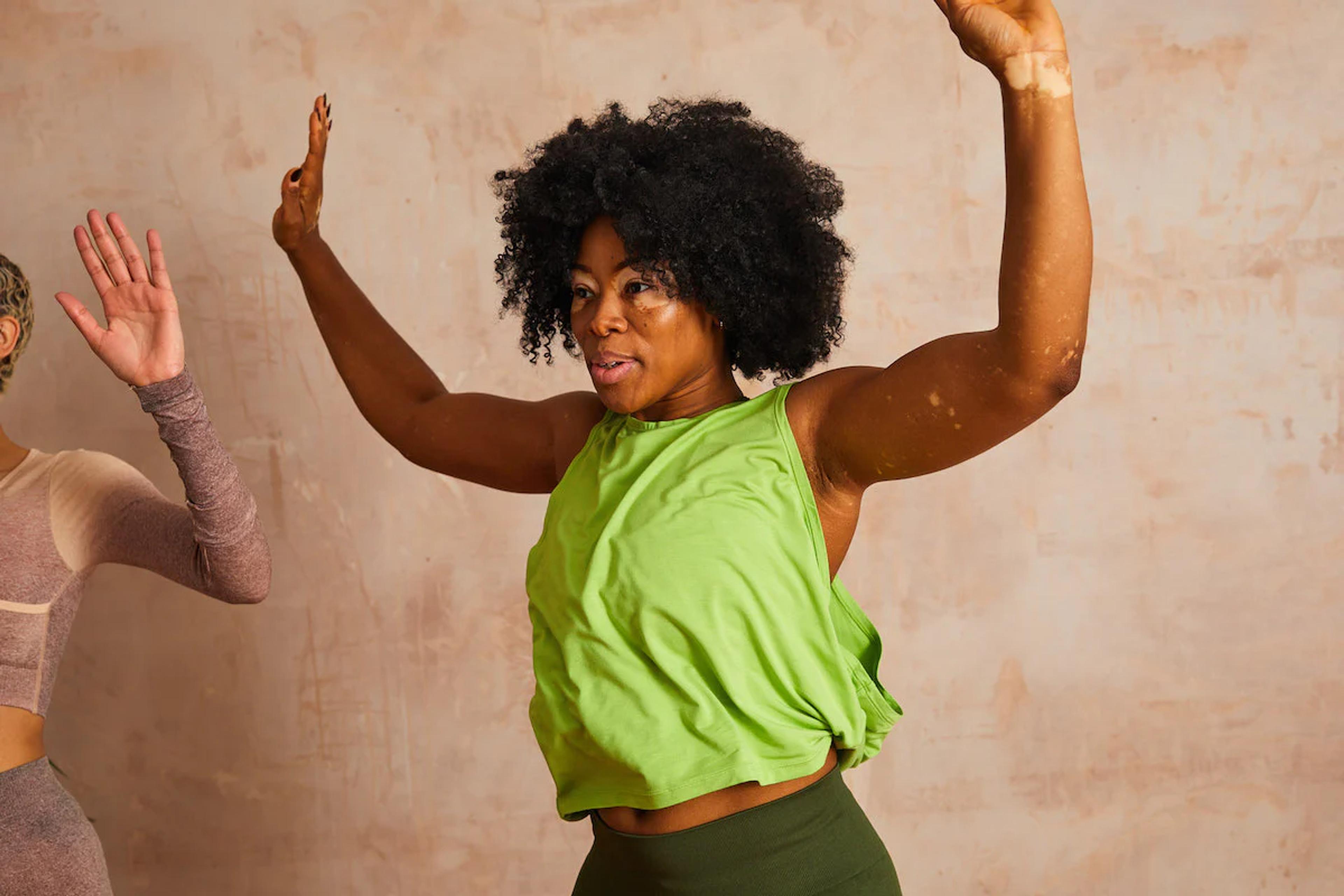woman doing star jumps in active gear as part of her workout