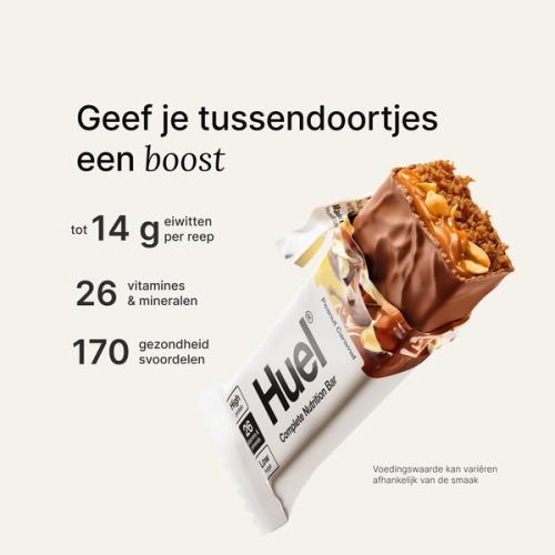 A Huel Complete Nutrition bar with a peanut and caramel filling, set against a beige-colour background