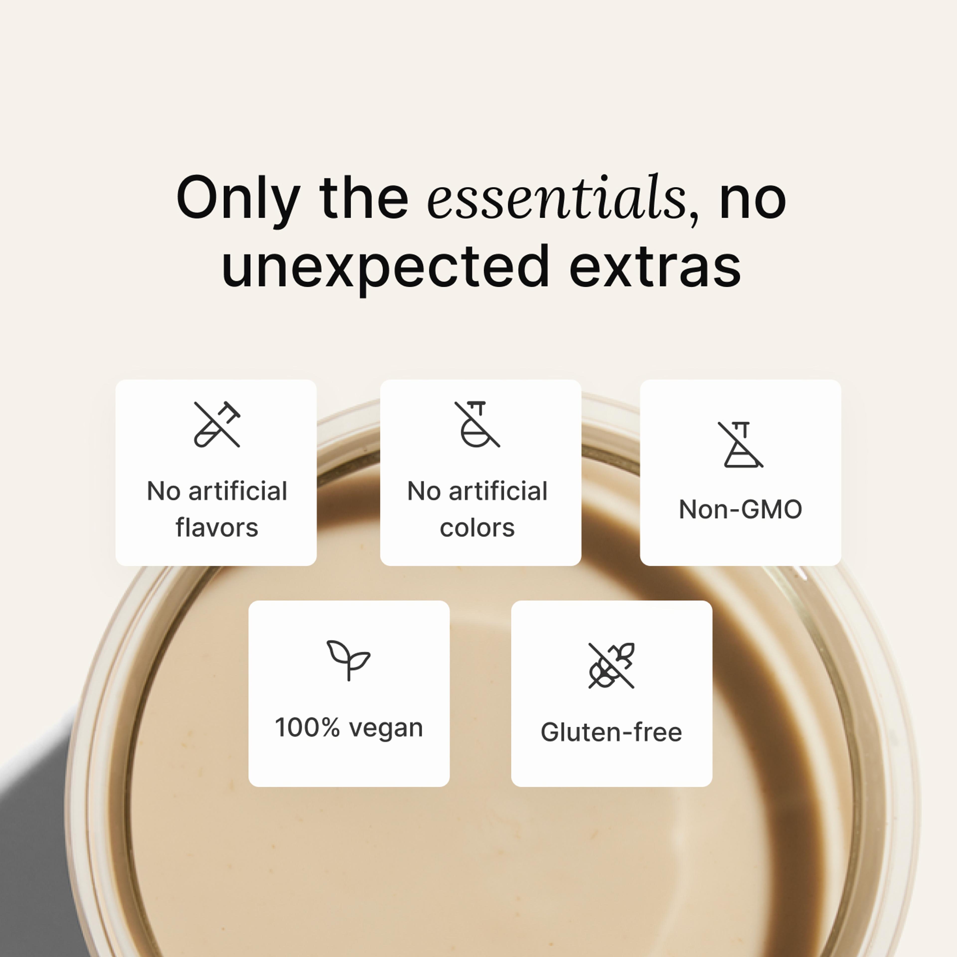 A glass of Huel complete protein shake on a neutral colour background