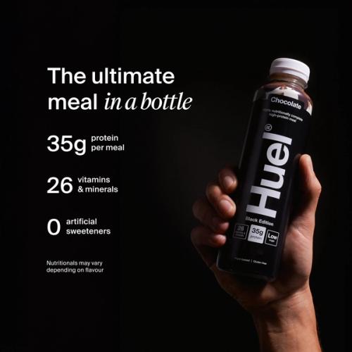 a hand holding a Bottle of Huel RTD with key benefits written next to it