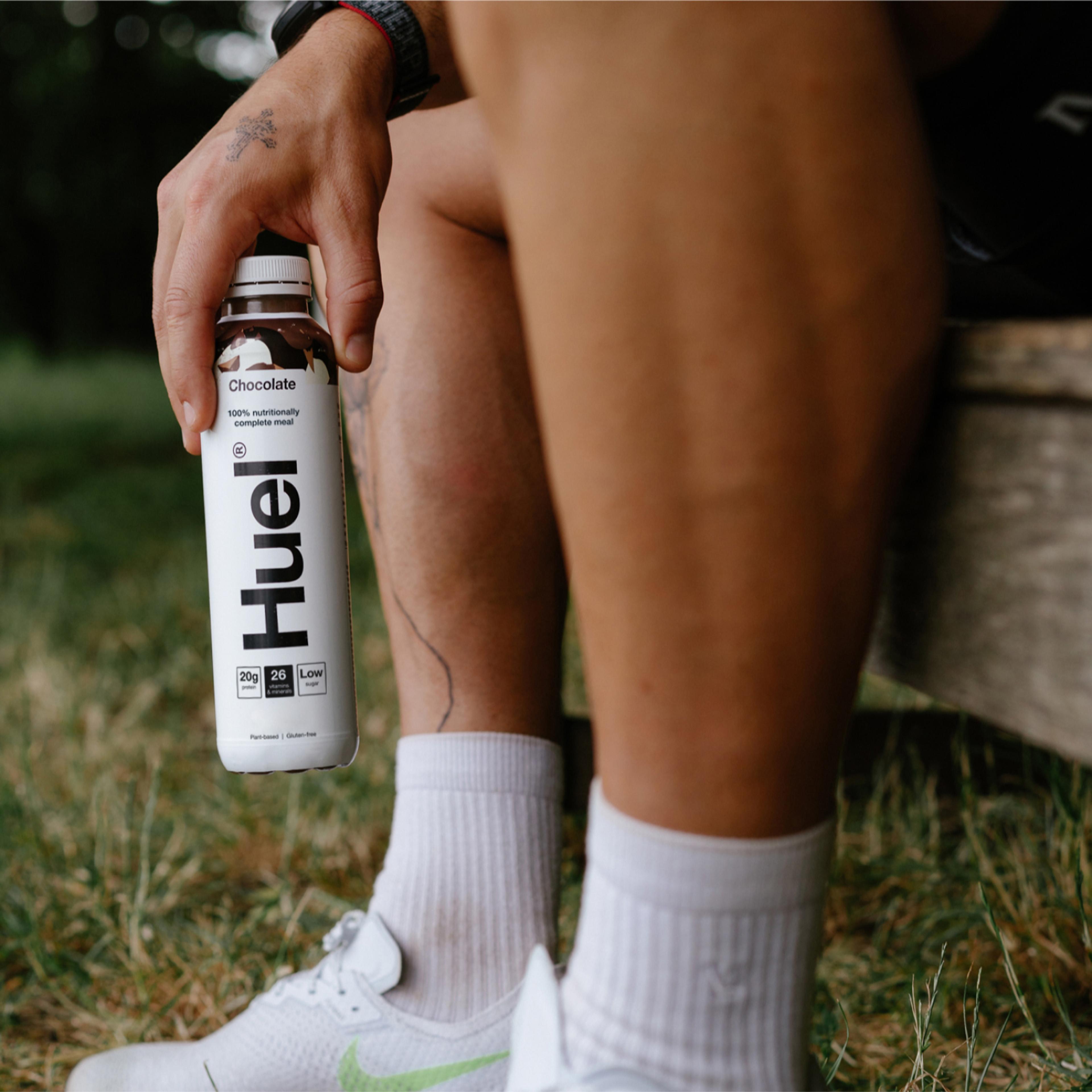 An image of a person holding a Huel Chocolate RTD