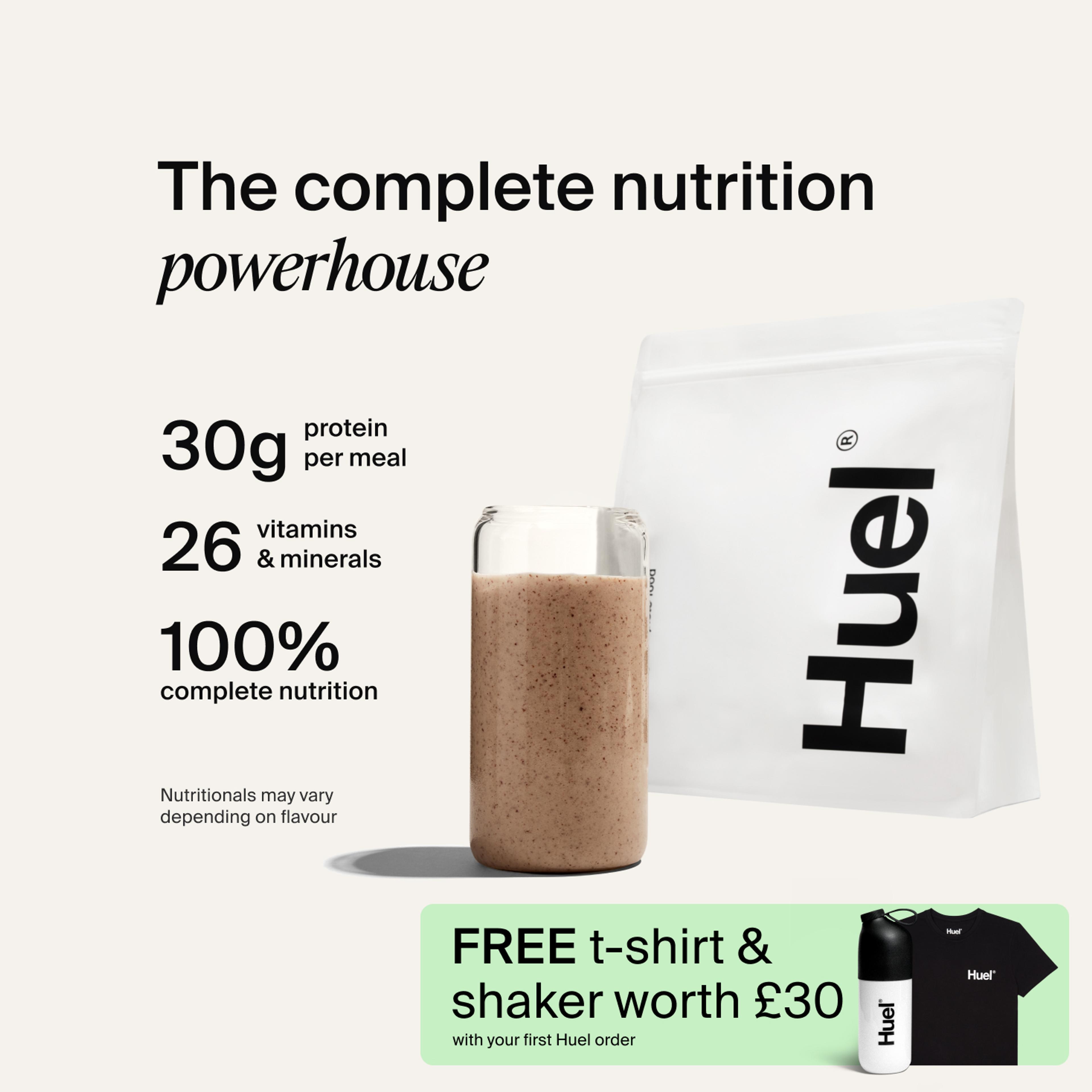 A bag of Huel powder next to a glass containing a Huel drink on a neutral background