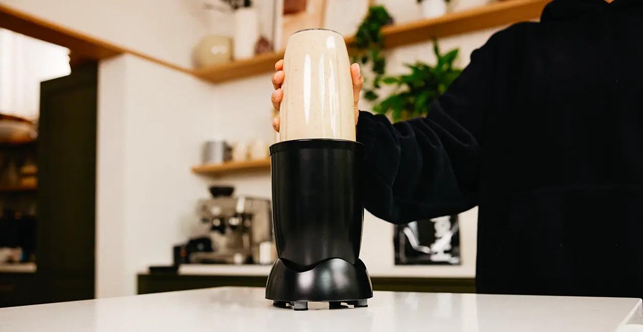 a blender maknig a Huel meal replacement shake in a kitchen