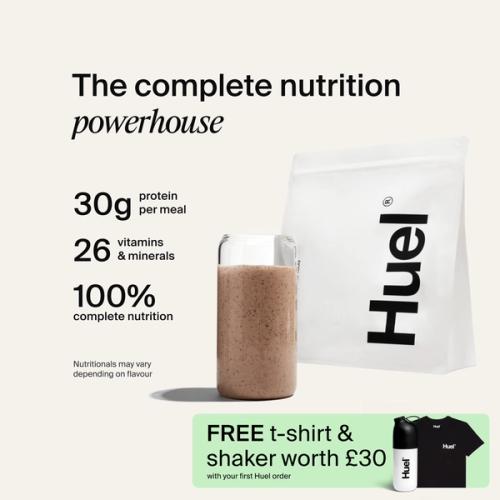 A bag of Huel powder next to a glass containing a Huel drink on a neutral background